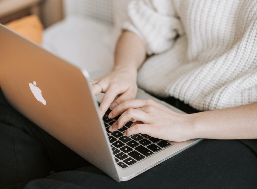 Woman typing at computer.