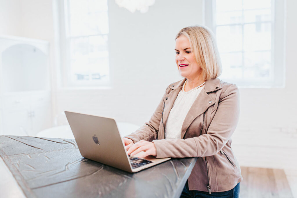 Melissa Trotman, owner of Vital You Functional Medicine based in Annapolis, Maryland, working at her computer.