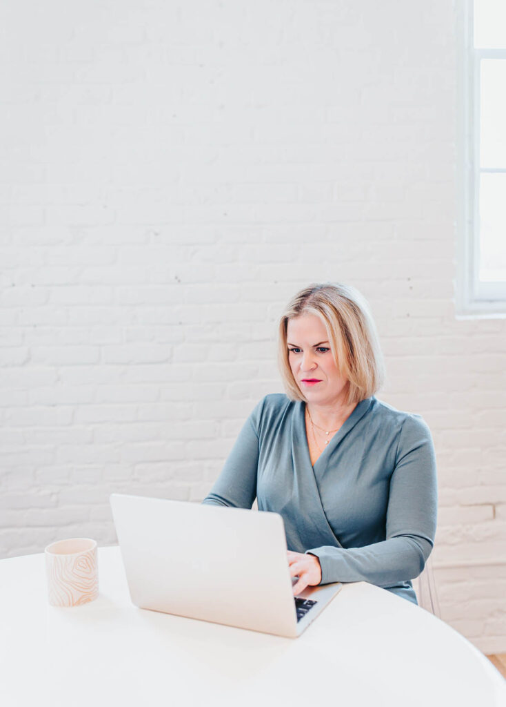 Melissa Trotman, owner of Vital You Functional Medicine based in Annapolis, Maryland, working at her computer.