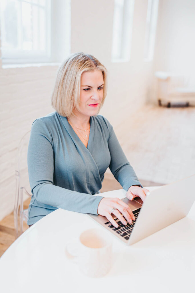 Melissa Trotman, owner of Vital You Functional Medicine based in Annapolis, Maryland, working at her computer.